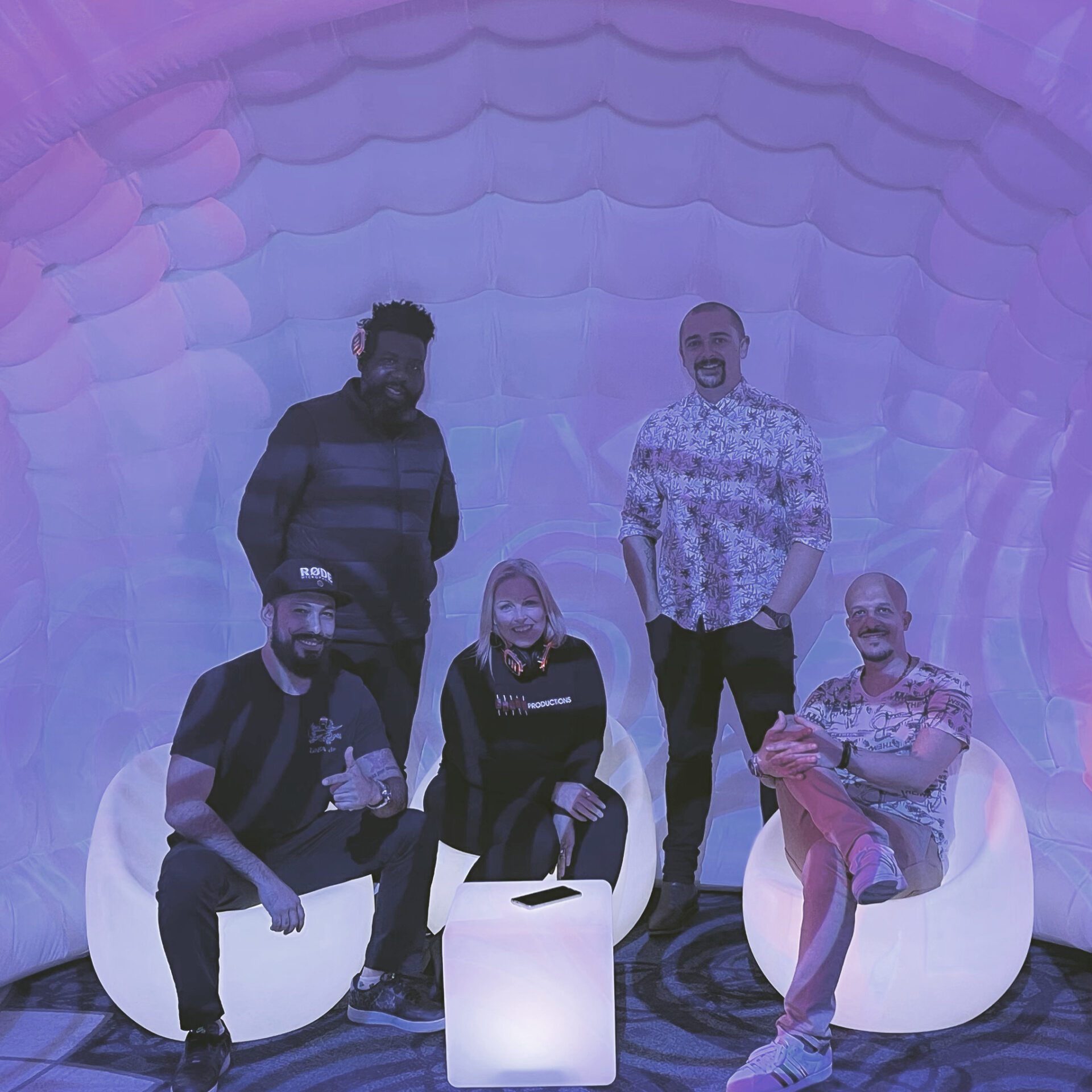 Osmic team with illuminated event furniture inside an inflatable igloo
