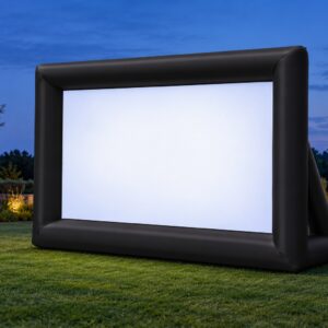 Outdoor inflatable movie screen set up on a well-manicured lawn at twilight.