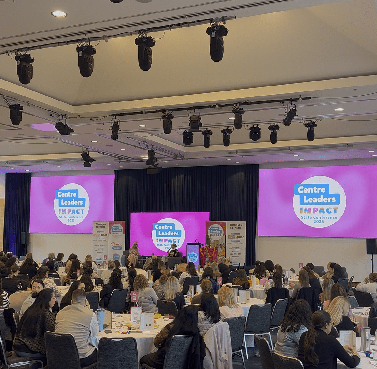 Corporate event ballroom with lighting and presentation screens