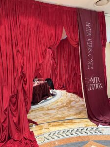 Luxurious Red Draped Curtains Framing a Wedding Reception Area with a Banner Reading Bride Vibes at Right.