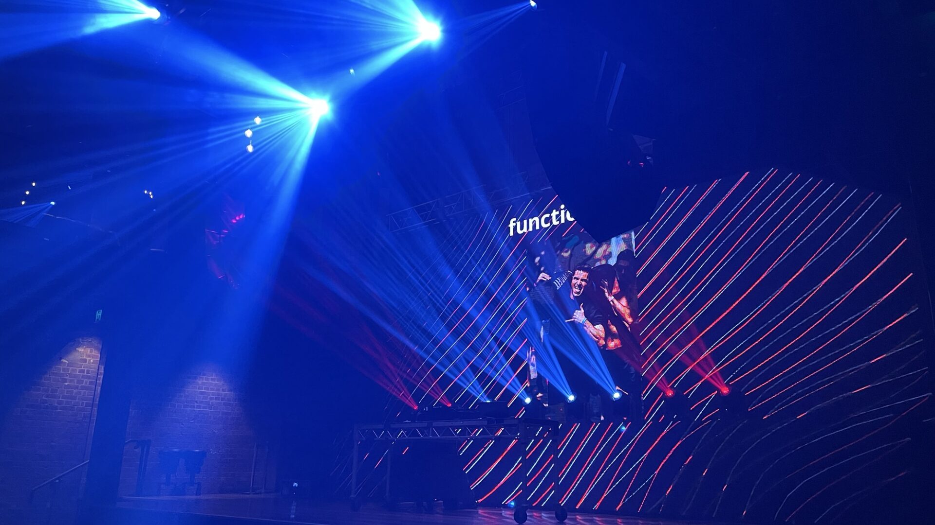 Blue stage lighting and an LED backdrop during a live event