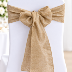 White chair with a gold fabric sash tied in a bow at the back.