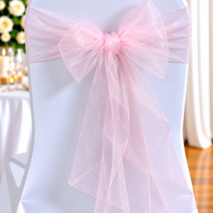 Organza Light Pink | Osmic Productions White Chair Dressed with a Soft Pink Tulle Bow Tied at the Back, Used for a Wedding or Event Setting