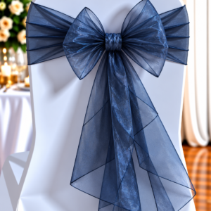 White chair with a navy blue organza sash tied in a large bow for formal event décor.