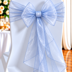 Chair Covered in Light Blue Fabric with a Large Sheer Blue Bow at the Back, Set for a Wedding Reception.