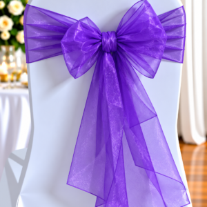 White Chair Draped in a White Cover with a Large Purple Organza Bow Tied at the Back for Event Decoration