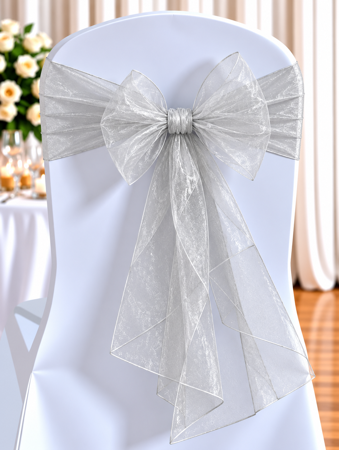 Organza Silver | Osmic Productions Chair Covered in Pale Blue Fabric with a Large Silver Bow for a Wedding Reception Backdrop.