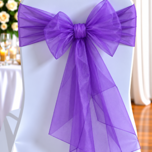 Organza Violet | Osmic Productions White Chair with a Purple Organza Bow Sash at a Formal Event, Likely a Wedding Reception Decor.