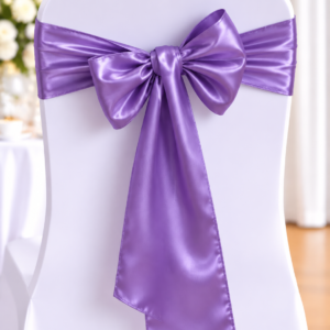 White banquet chair with a lavender satin bow tied around the back