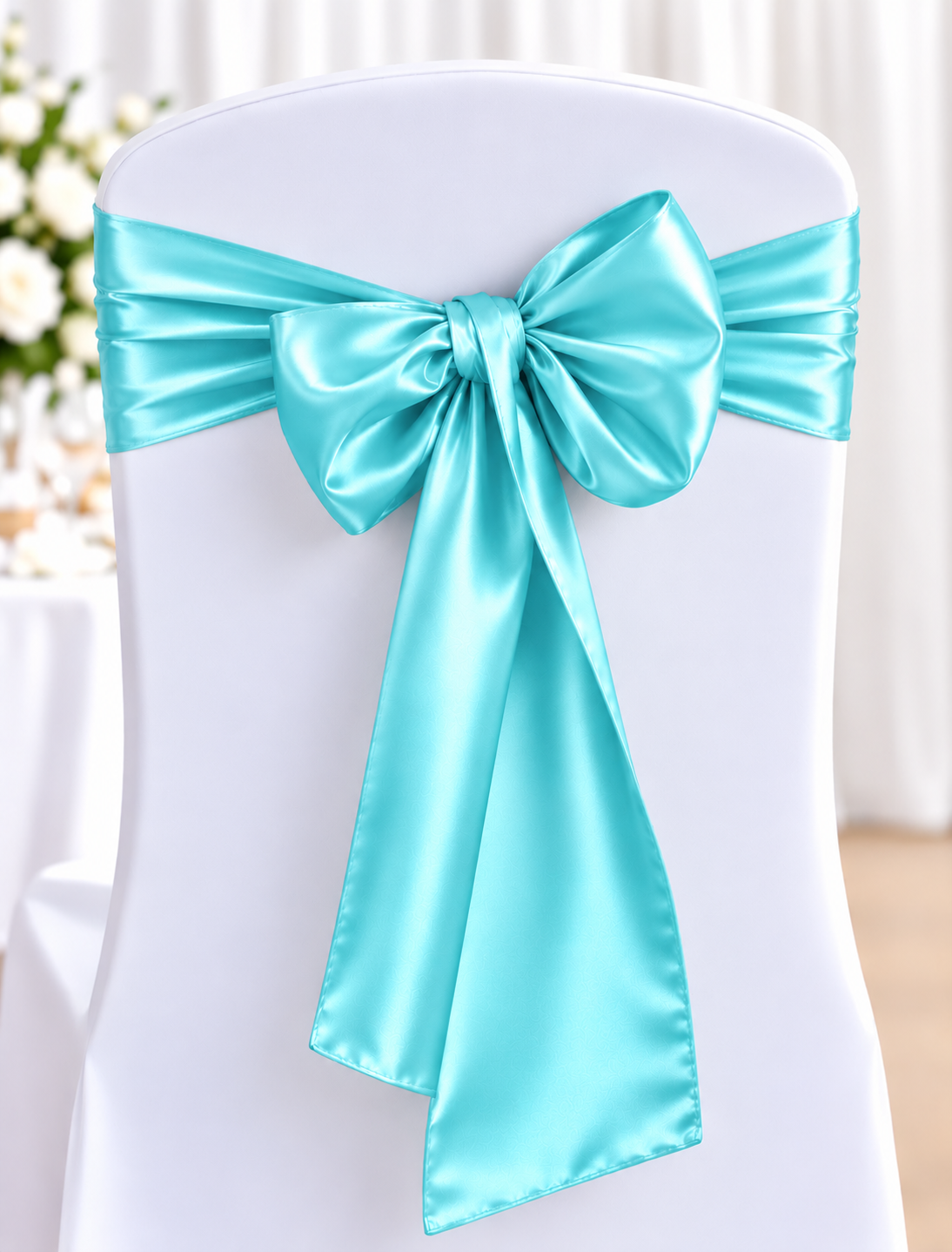 Satin Turquoise Lighter | Osmic Productions White Chair Covered in Fabric with a Bright Turquoise Satin Sash Tied in a Large Bow at the Back, Wedding Decor.