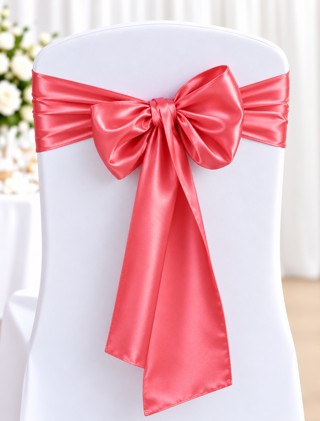 Satin Watermelon | Osmic Productions White Chair Covered in a White Fabric with a Pink Satin Ribbon Tied in a Large Bow Around the Back, Typical of Wedding or Event Decor