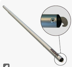 Long stainless steel probe/toy-like tool with a rounded end, shown with a circular magnified close-up of the tip components at the bottom end.