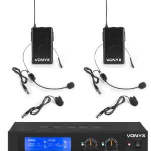 Dual Wireless Microphone System with Two Bodypack Transmitters, Each with a Lavalier Mic and Microphone Capsule, Plus a Two-channel Receiver Showing Blue Displays. Brand: Vonyx.
