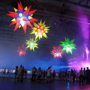 Colourful illuminated star-shaped inflatables in an event setting